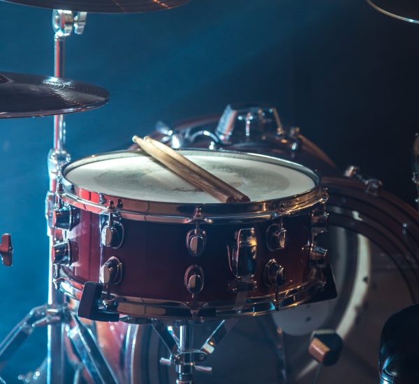 musical instruments drum kit, close-up, flash of light, a beautiful light in the background with copy space